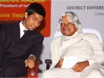Srikanth Bolla sitting next to Dr. APJ Abdul Kalam during an event.