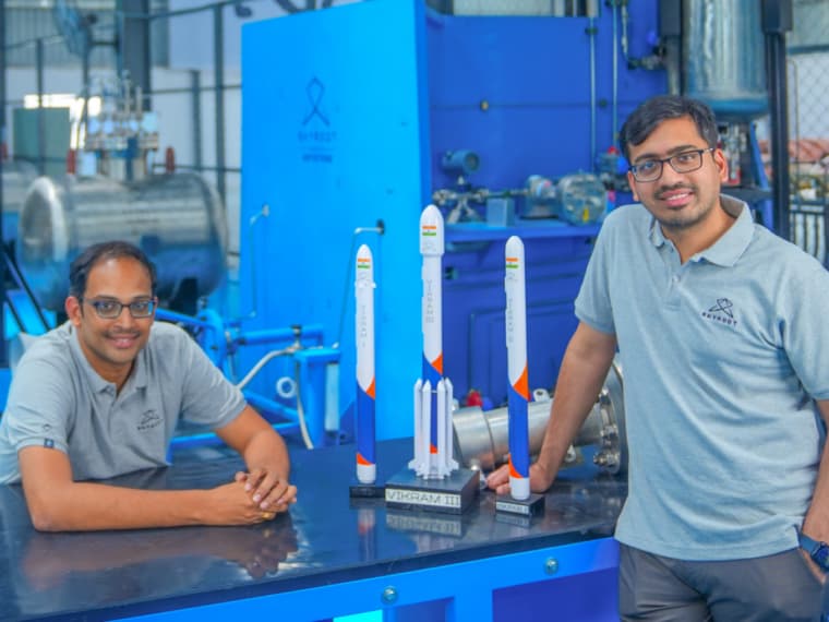 Skyroot Aerospace founders Pawan Kumar Chandana and Naga Bharath Daka pose with scale models of Vikram rockets at the company’s Hyderabad facility.