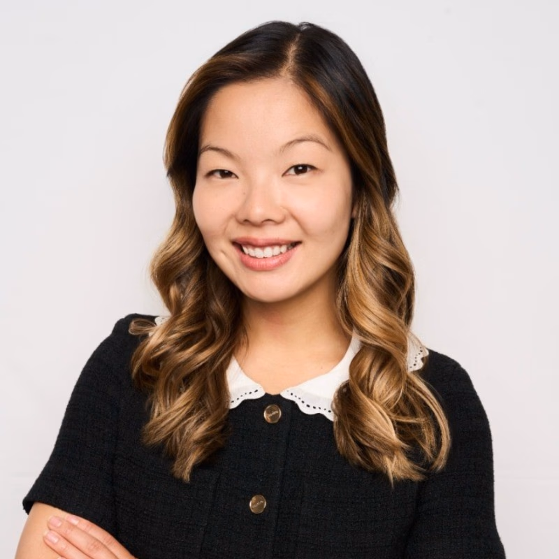 Portrait of a woman in a black outfit smiling at the camera.