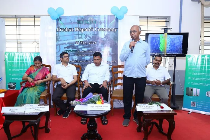 Four seated dignitaries and one standing speaker at the HYDGEN Product Dispatch Ceremony on 2 Nov 2025, with event backdrop and Hydrogen equipment display.